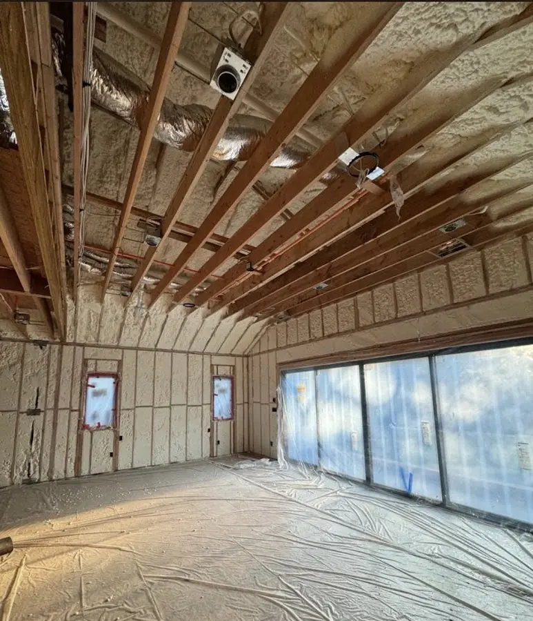 Interior walls and ceiling insulated with spray foam during new construction in Somerville